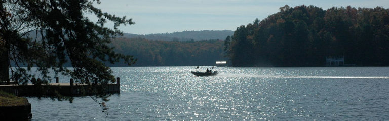 Fishing boat driving on Lake Burton from LaPrade's